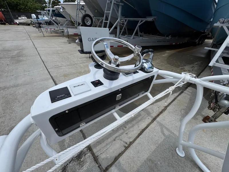 Slide: The Image of Steering console of 2020 Twin Vee 310 CC GF boat with Suzuki controls. - 46