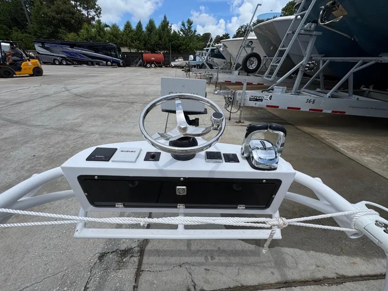 Slide: The Image of Steering console of 2020 Twin Vee 310 CC GF boat in a marina setting. - 47