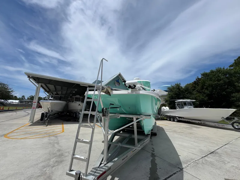 Slide: The Image of 2020 Twin Vee 310 CC GF boat on trailer under clear sky. - 6