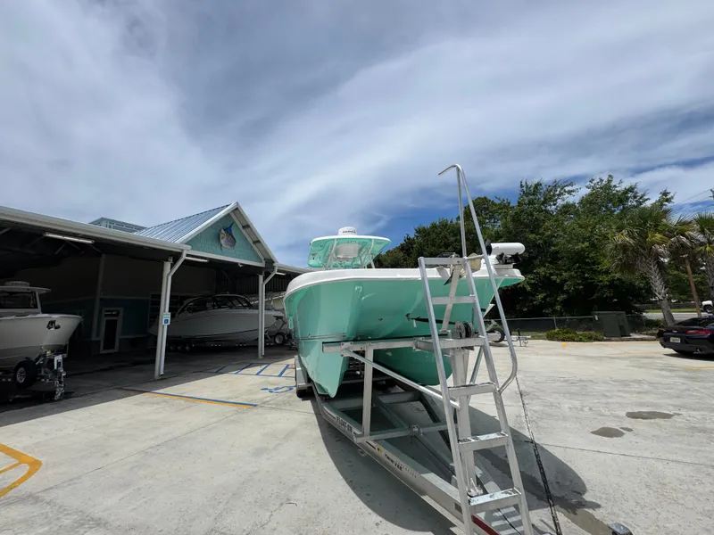 Slide: The Image of 2020 Twin Vee 310 CC GF boat on trailer, parked outdoors near a building. - 8