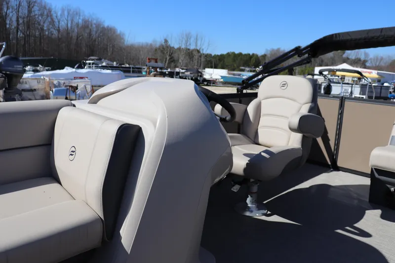 Slide: The Image of Interior of 2025 Flagship Freedom 18 boat with beige seating and steering console. - 5