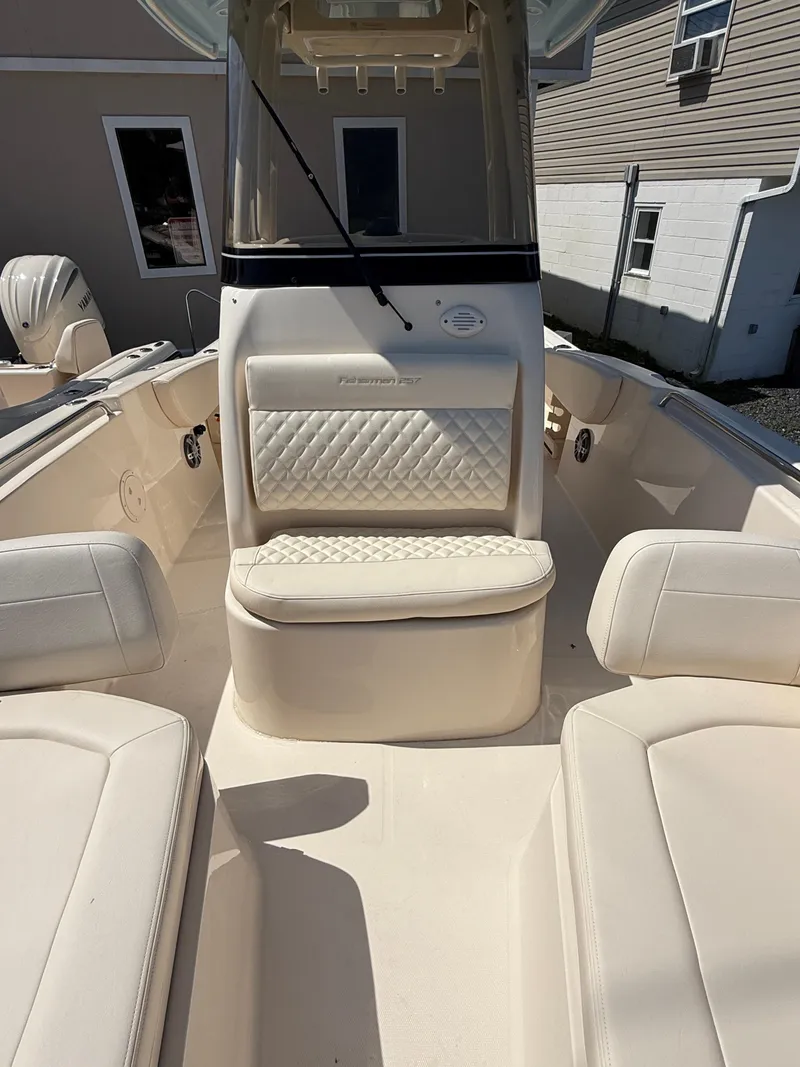 Slide: The Image of 2025 Grady-White Fisherman 257 boat interior with white cushioned seating. - 10