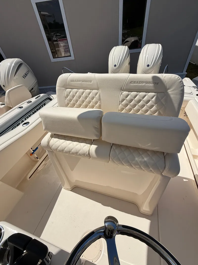 Slide: The Image of 2025 Grady-White Fisherman 257 boat interior with plush seating and dual Yamaha engines. - 8