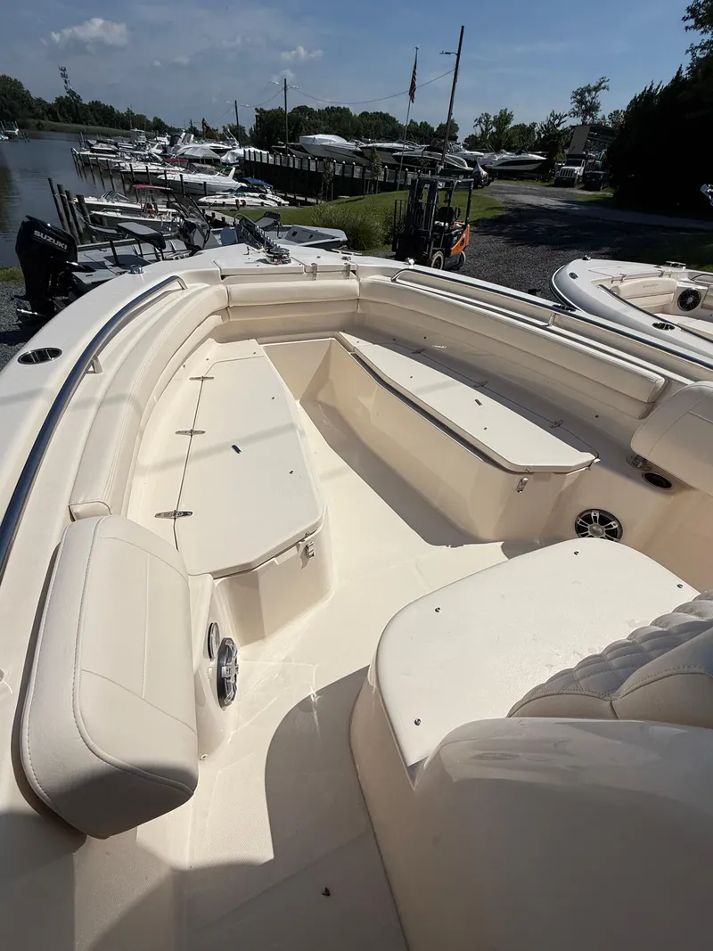 Slide: The Image of 2025 Grady-White Fisherman 257 boat interior with seating and storage, docked at marina. - 9