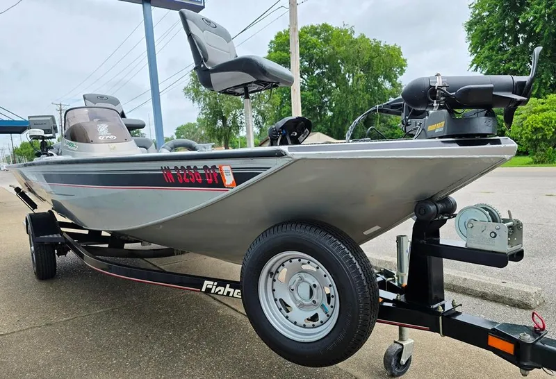 Slide: The Image of 2007 Fisher Pro Hawk 170 boat on trailer, parked outdoors, featuring a sleek design. - 11