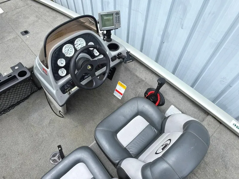 Slide: The Image of 2007 Fisher Pro Hawk 170 boat cockpit with steering wheel and gauges. - 3