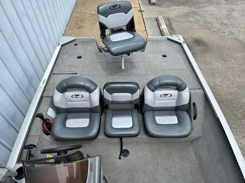 Slide: The Image of 2007 Fisher Pro Hawk 170 boat interior with gray seating and steering console. - 4