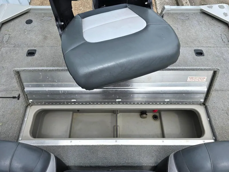 Slide: The Image of 2007 Fisher Pro Hawk 170 boat interior with open storage compartment and gray seating. - 9
