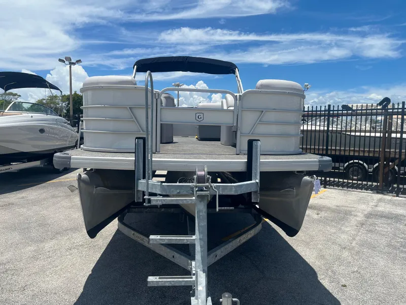 Slide: The Image of 2022 Godfrey SWEETWATER 2286 SFL pontoon boat on trailer under blue sky. - 3
