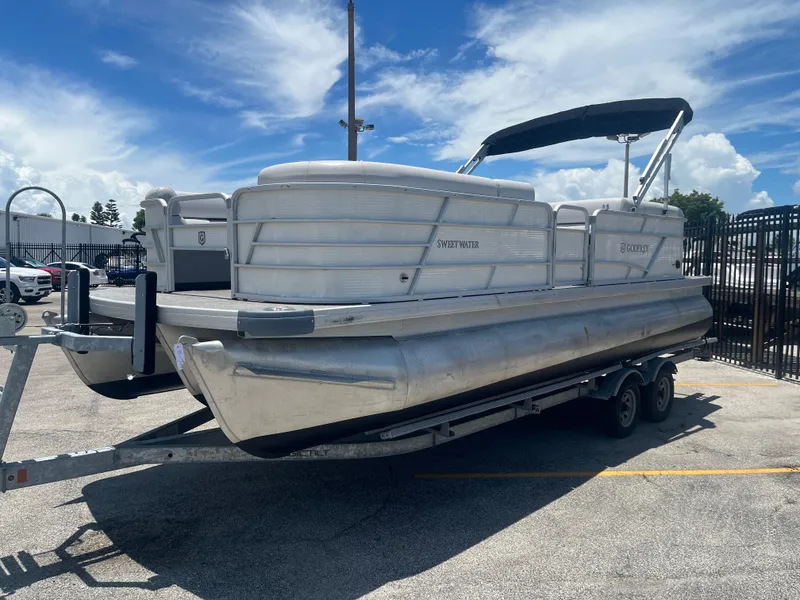 Slide: The Image of 2022 Godfrey SWEETWATER 2286 SFL pontoon boat on trailer under blue sky. - 4