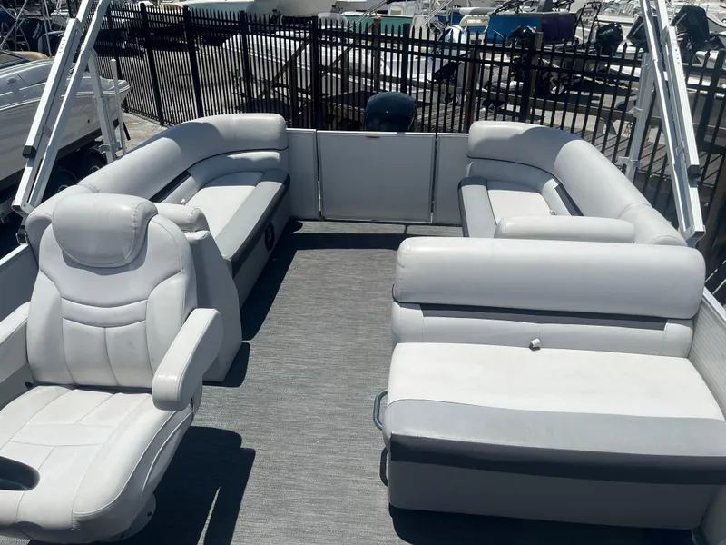 Slide: The Image of 2022 Godfrey SWEETWATER 2286 SFL pontoon boat interior with gray seating and helm chair. - 9
