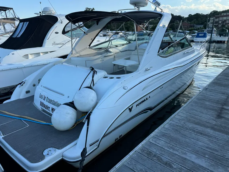 Slide: The Image of 2006 Formula 370 SS boat docked at marina, featuring sleek design and white exterior. - 12