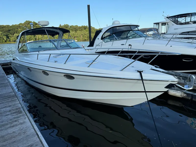Slide: The Image of 2006 Formula 370 SS boat docked on calm water, surrounded by other boats. - 13