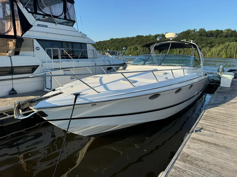 Slide: The Image of 2006 Formula 370 SS boat docked beside another yacht on a sunny day. - 2