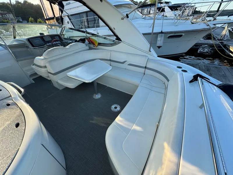 Slide: The Image of 2006 Formula 370 SS boat interior with white seating and table, docked at marina. - 5