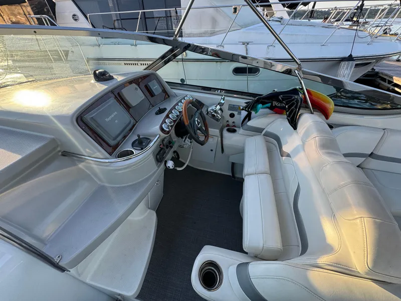 Slide: The Image of Interior of a 2006 Formula 370 SS boat with white seating and control panel. - 6