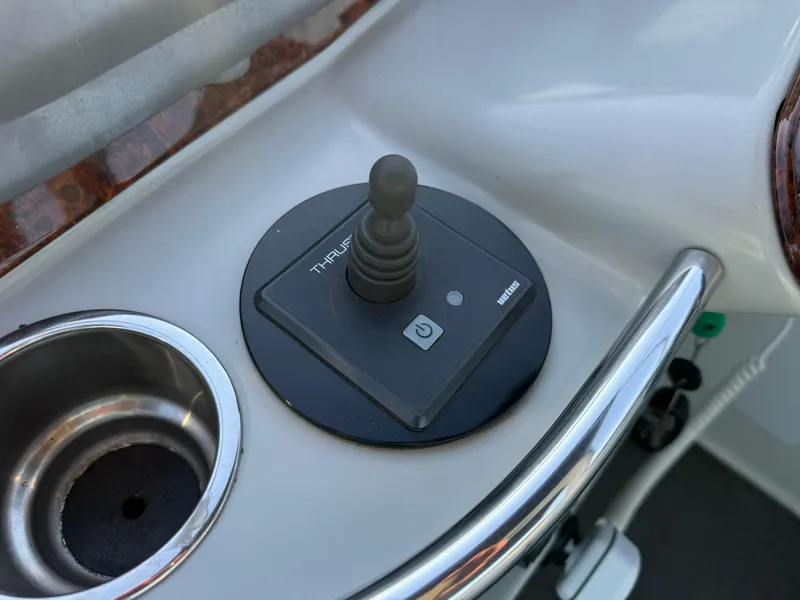Slide: The Image of Joystick control on 2006 Formula 370 SS boat dashboard, next to a cup holder. - 8