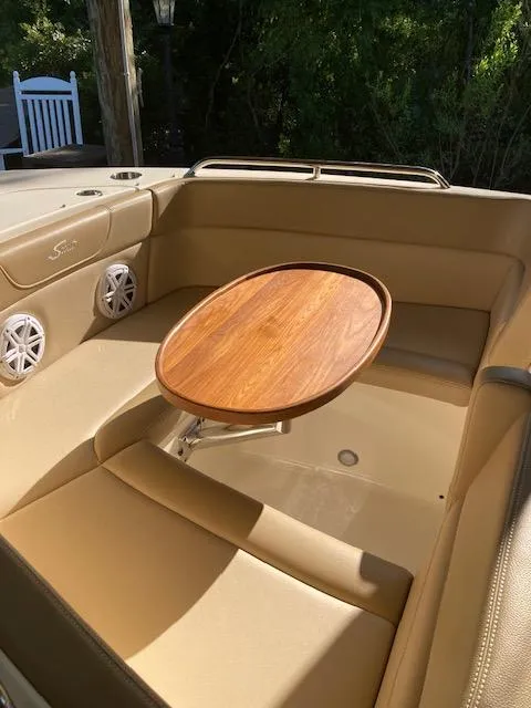 Slide: The Image of 2021 Scout 215 Dorado boat interior with tan seating and speaker. - 17