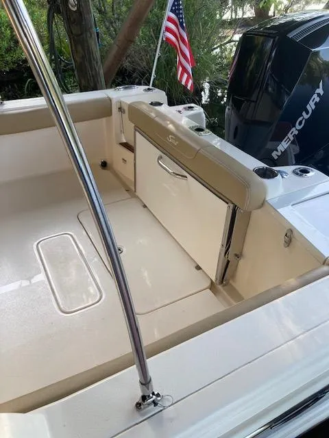 Slide: The Image of 2021 Scout 215 Dorado boat interior with Mercury engine and American flag. - 18