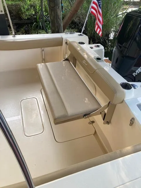 Slide: The Image of 2021 Scout 215 Dorado boat interior with foldable seat and American flag. - 19