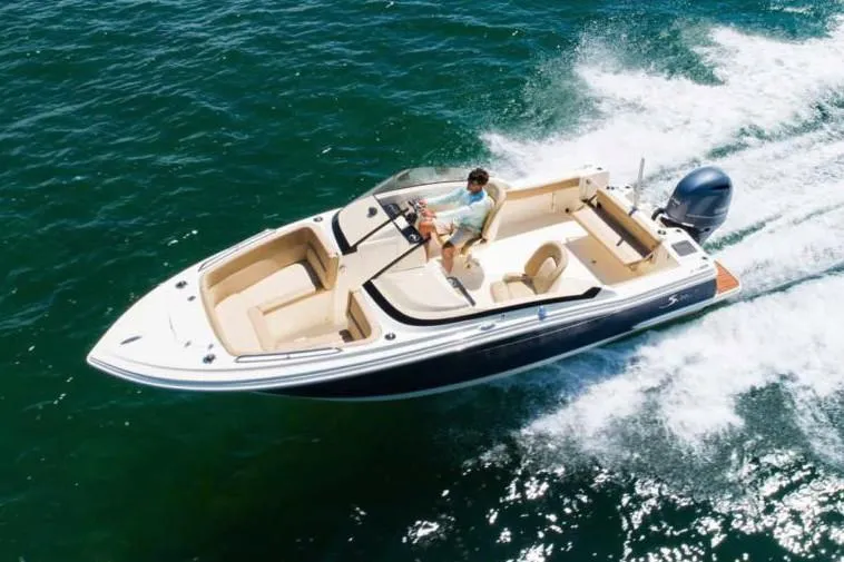 Slide: The Image of Manufacturer Provided Image: 2021 Scout 215 Dorado boat cruising on open water. - 2