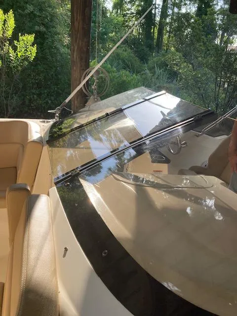 Slide: The Image of 2021 Scout 215 Dorado boat interior with beige seating and sleek dashboard. - 22