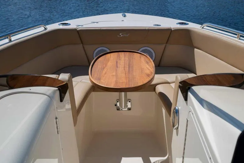 Slide: The Image of Manufacturer Provided Image: 2021 Scout 215 Dorado boat interior with wooden table and cushioned seating. - 4