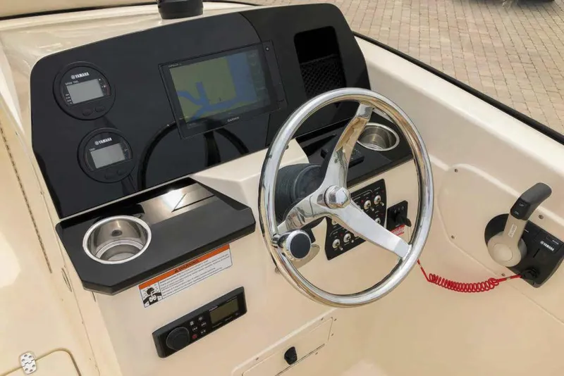 Slide: The Image of Manufacturer Provided Image: 2021 Scout 215 Dorado boat dashboard with steering wheel, navigation system, and controls. - 5