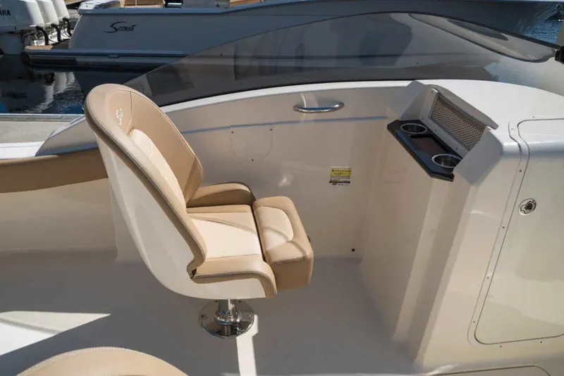 Slide: The Image of Manufacturer Provided Image: 2021 Scout 215 Dorado boat interior with beige captain's chair and console. - 7