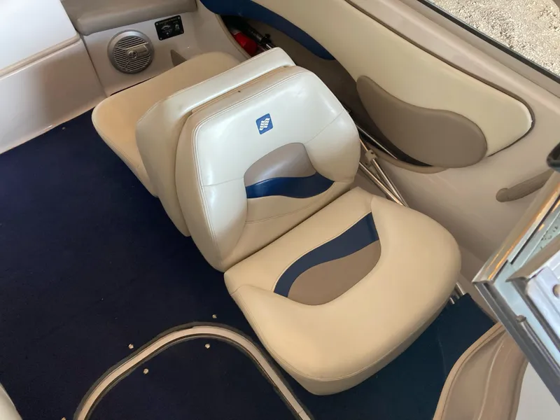 Slide: The Image of 1998 Four Winns Horizon QX boat interior with beige and blue seating. - 10