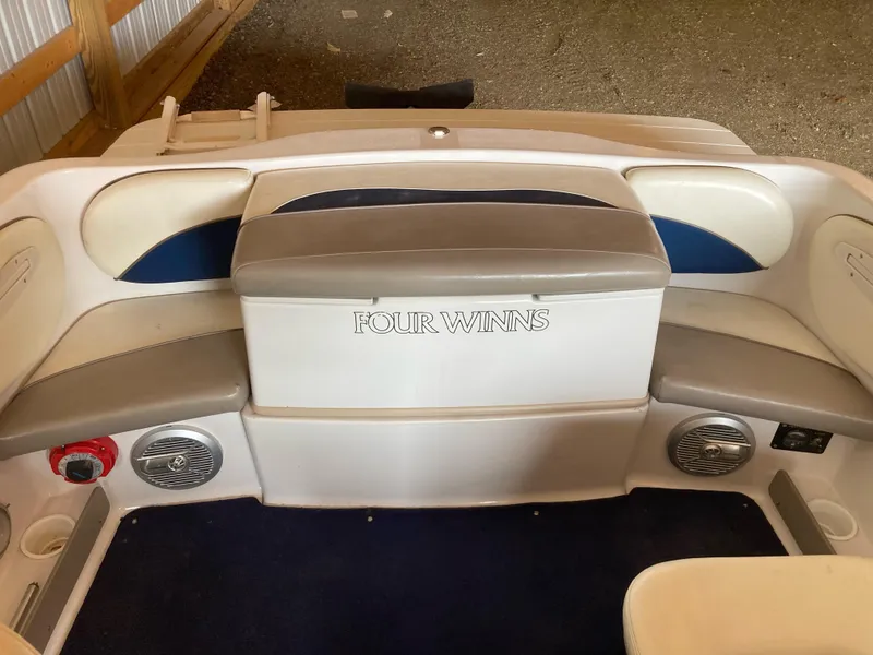 Slide: The Image of Interior of a 1998 Four Winns Horizon QX boat with seating and speakers. - 11