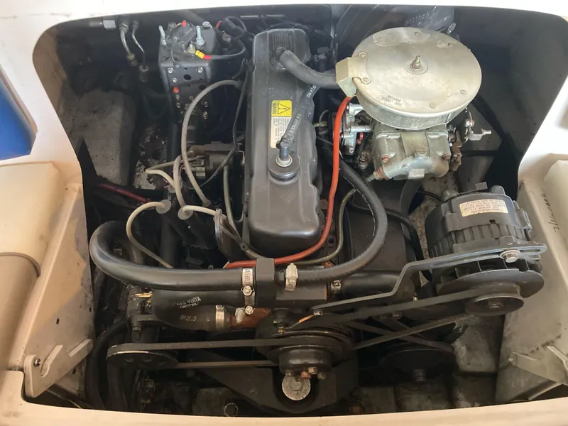 Slide: The Image of Engine compartment of a 1998 Four Winns Horizon QX boat, showing detailed components. - 13