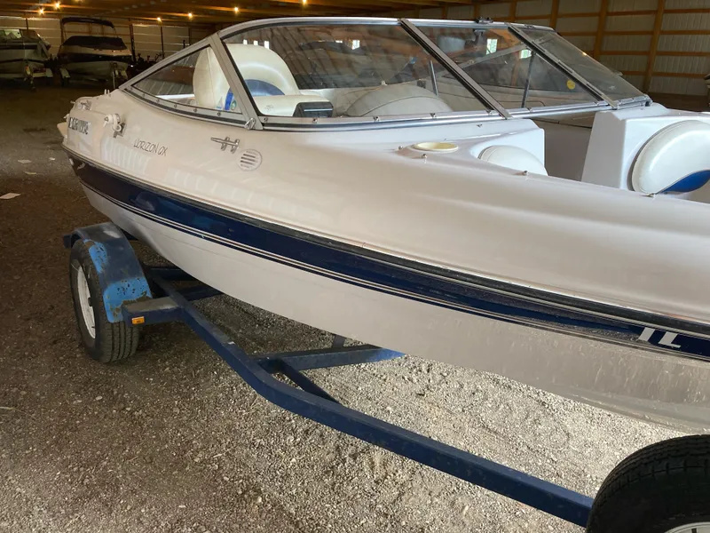 Slide: The Image of 1998 Four Winns Horizon QX boat on trailer in storage facility. - 2