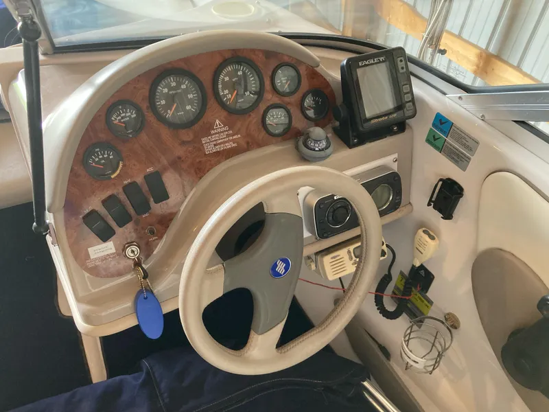 Slide: The Image of 1998 Four Winns Horizon QX boat dashboard with gauges and steering wheel. - 6