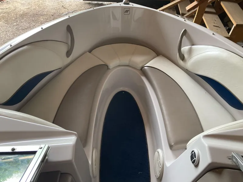 Slide: The Image of 1998 Four Winns Horizon QX boat interior with cushioned seating and blue carpet. - 7