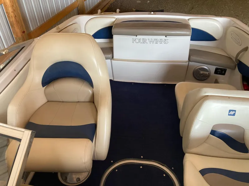 Slide: The Image of 1998 Four Winns Horizon QX boat interior with beige and blue seating. - 9