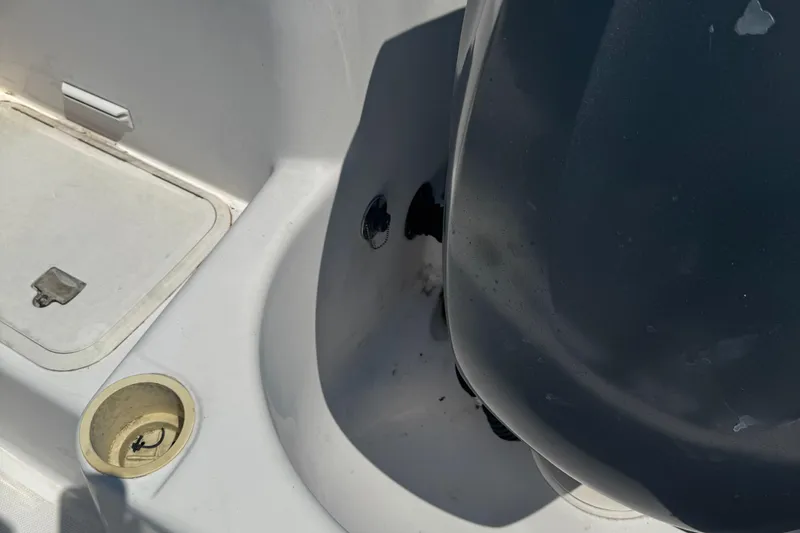 Slide: The Image of 2002 Pro-Line 22 Sport Center Console boat interior with storage compartment and engine detail. - 3