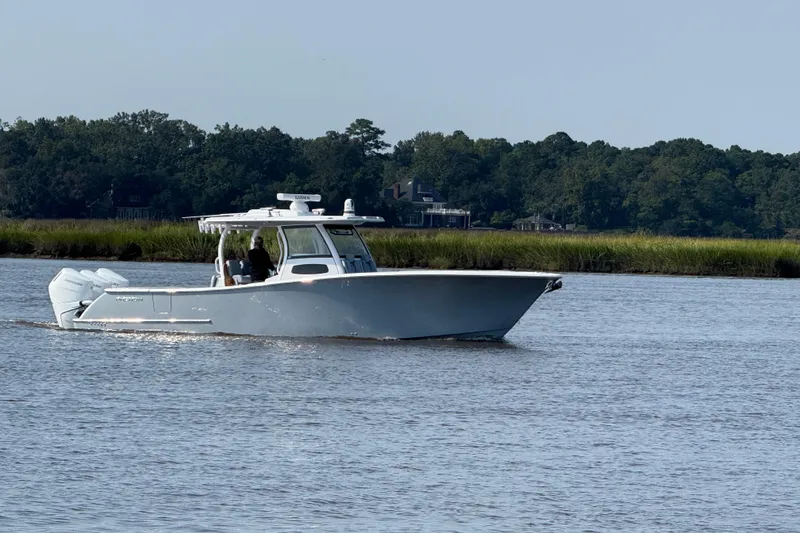 Slide: The Image of 2026 Phenom 37 Center Console boat interior with open storage compartments on calm water. - 13