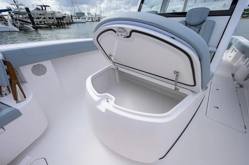 Slide: The Image of 2026 Phenom 37 Center Console boat with open storage compartment, docked at marina. - 15