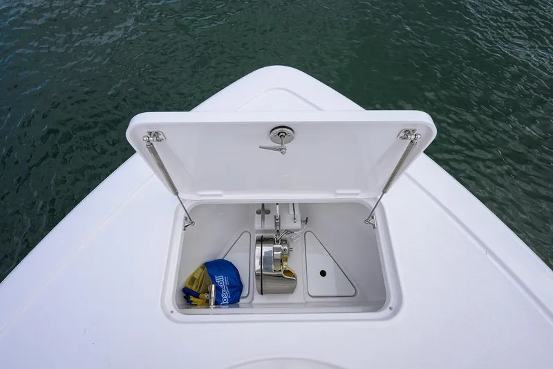 Slide: The Image of Open storage compartment on 2026 Phenom 37 Center Console boat, near water. - 16