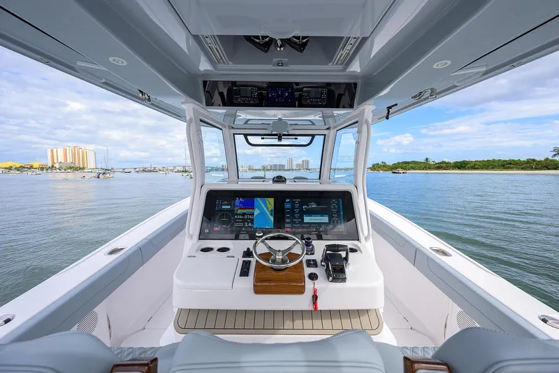 Slide: The Image of 2026 Phenom 37 Center Console boat interior with advanced navigation system on calm waters. - 21