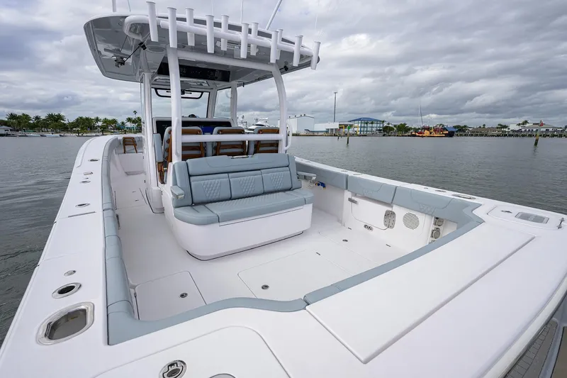 Slide: The Image of 2026 Phenom 37 Center Console boat with spacious deck and seating, docked by the waterfront. - 26