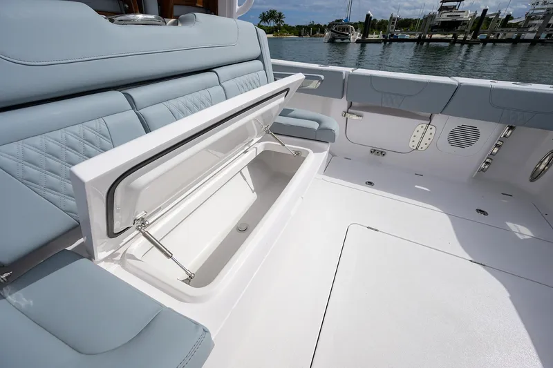 Slide: The Image of 2026 Phenom 37 Center Console boat with open storage compartment, docked by the water. - 29