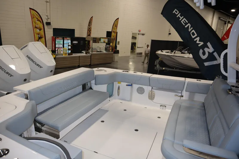 Slide: The Image of 2026 Phenom 37 Center Console boat with four 400 V10 engines on water. - 3