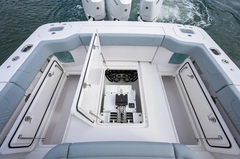 Slide: The Image of 2026 Phenom 37 Center Console boat with open storage compartments and visible engine area. - 32