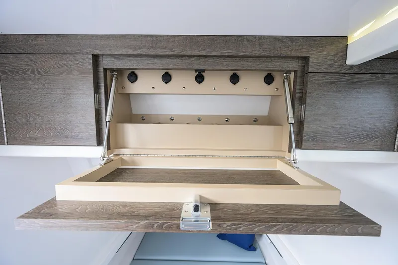 Slide: The Image of Open storage compartment in 2026 Phenom 37 Center Console boat interior. - 36