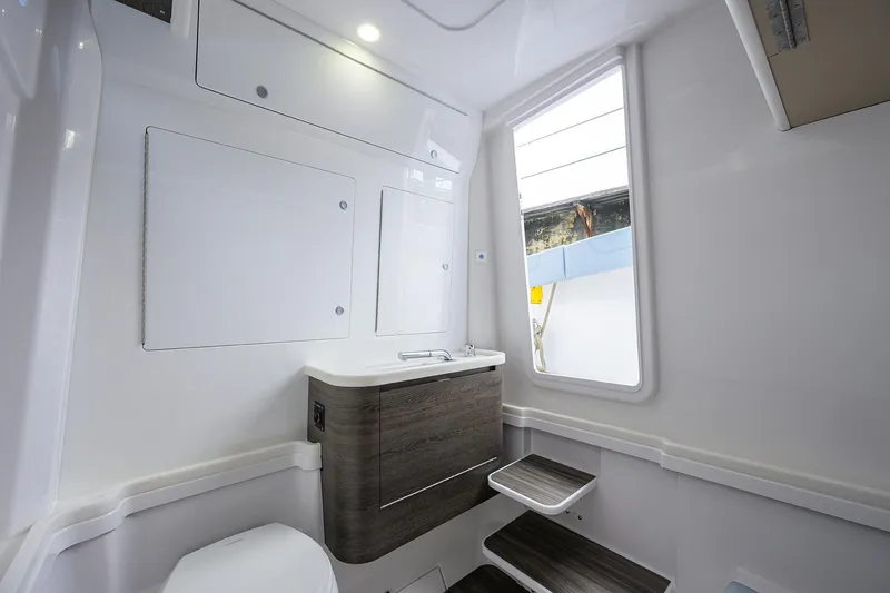 Slide: The Image of Interior of 2026 Phenom 37 Center Console boat, featuring modern bathroom design. - 37