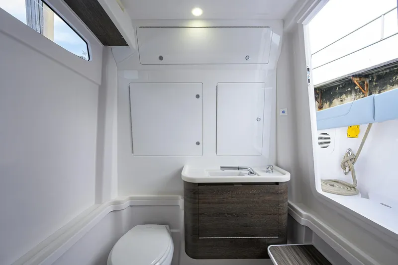 Slide: The Image of Modern bathroom interior on 2026 Phenom 37 Center Console boat, featuring sleek design and amenities. - 38