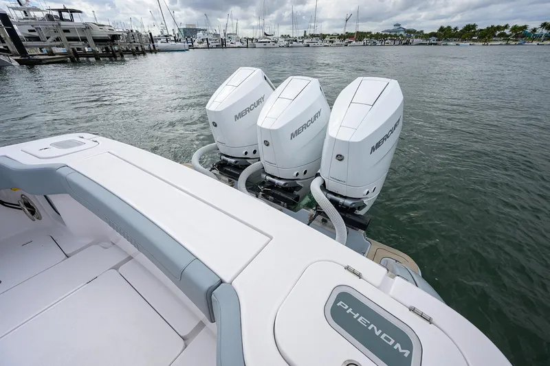 Slide: The Image of 2026 Phenom 37 Center Console boat with triple Mercury engines docked at marina. - 43