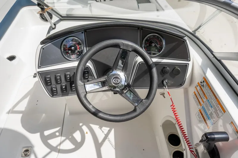 Slide: The Image of Steering console of 2025 Hurricane SunDeck 217 OB boat with gauges and controls. - 12